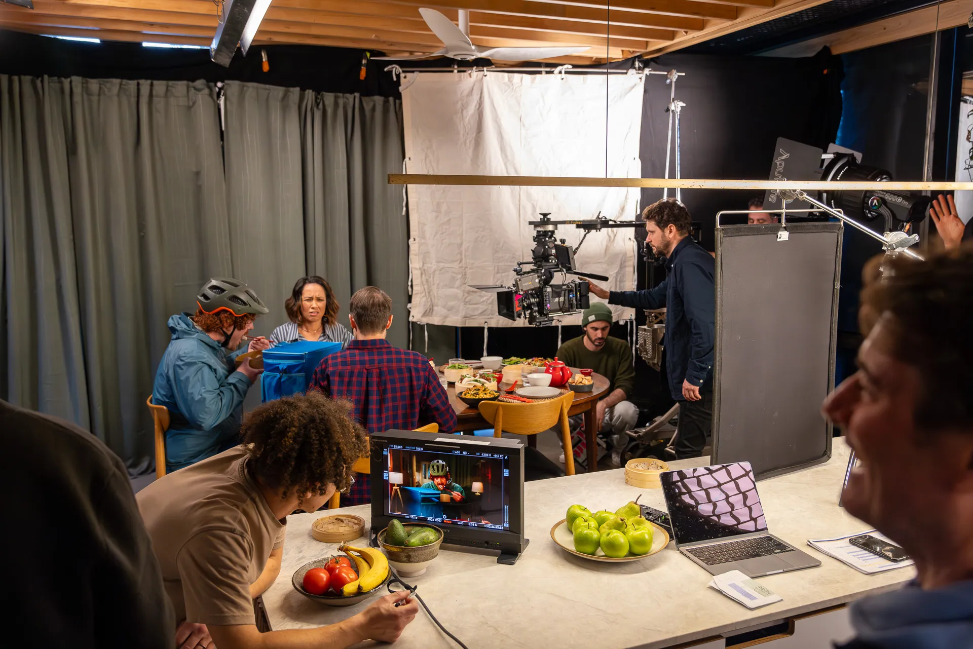 Comma Films crew around a monitor on set